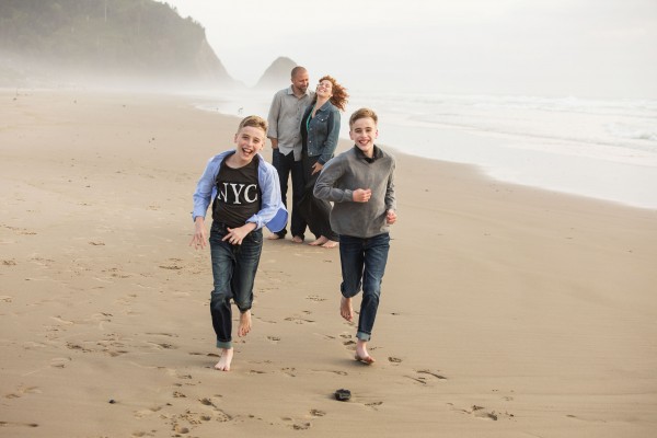 Photo of mother, father, and two children on the beach