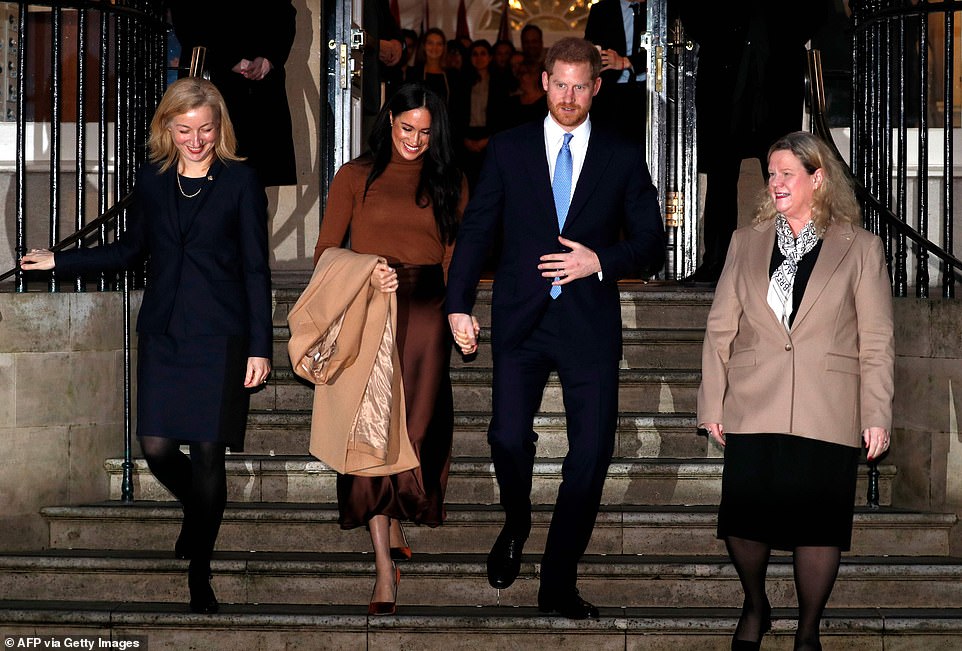 The Duke and Duchess of Sussex leave holding hands after visiting Canada House in London yesterday afternoon
