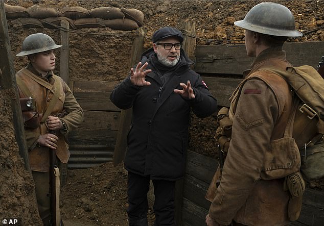 Sir Sam Mendes with actors Dean-Charles Chapman and George MacKay on the set of 1917