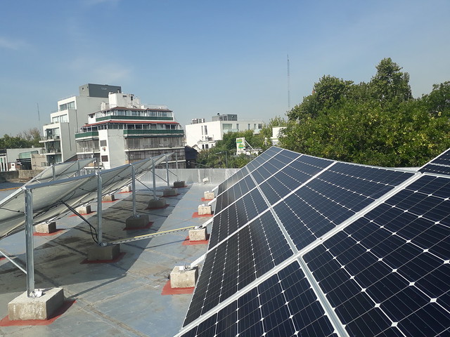 Solar panels nearly cover the entire rooftop of the Antonio Devoto High School in Buenos Aires. Until last year the rooftop area was not put to any use. The idea of using that space to generate renewable energy came from students in their final year in 2014, who presented a project to the Buenos Aires city legislature. Credit: Daniel Gutman/IPS