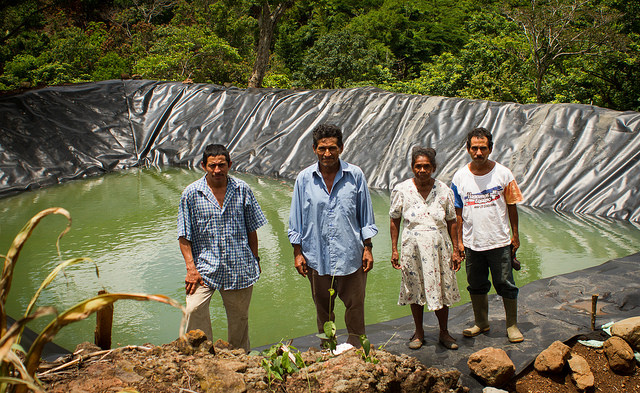A group of peasant farmers from El Salvador stand in front of one of the two rainwater tanks built in their village, La Colmena, in the municipality of Candelaria de la Frontera. The pond is part of a climate change adaptation project in the Central American Dry Corridor. Central American farmers like these and others from Brazil's semiarid Northeast have exchanged experiences on solutions for living with lengthy droughts. CREDIT: Edgardo Ayala/IPS