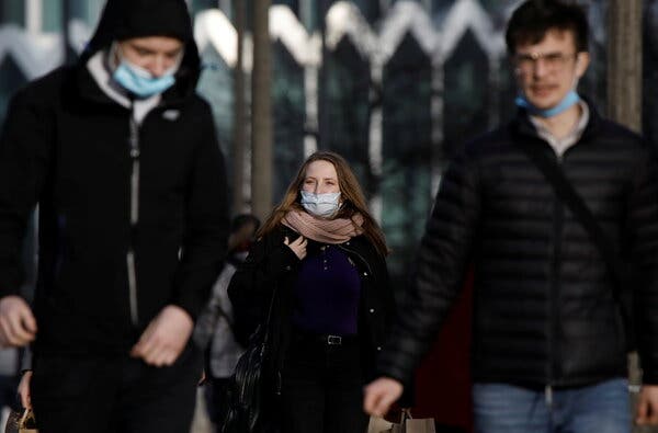 People wearing protective masks in central Warsaw on Wednesday. The government announced it would tigthen restrictions on face coverings.