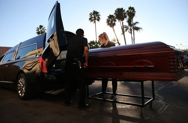 A Covid-19 victim being placed in a hearse in El Cajon, Calif., in January.
