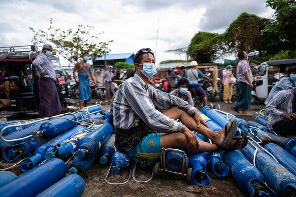 A man waiting to fill empty oxygen canisters outside a factory in Mandalay on Wednesday, in defiance of an order by Myanmar’s military that denies oxygen to private citizens.