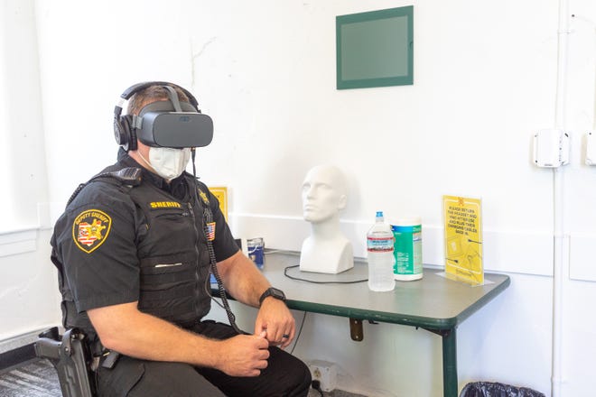 Deputy Jayson White, of the Athens County Sheriff's office, experiences the "Chet" training scenario at the Appalachian Law Enforcement Initiative event hosted at the Ohio University Police Department on Aug. 21. The specific training simulation that White watched aims to train law enforcement officers to appropriately address someone with mental illness.