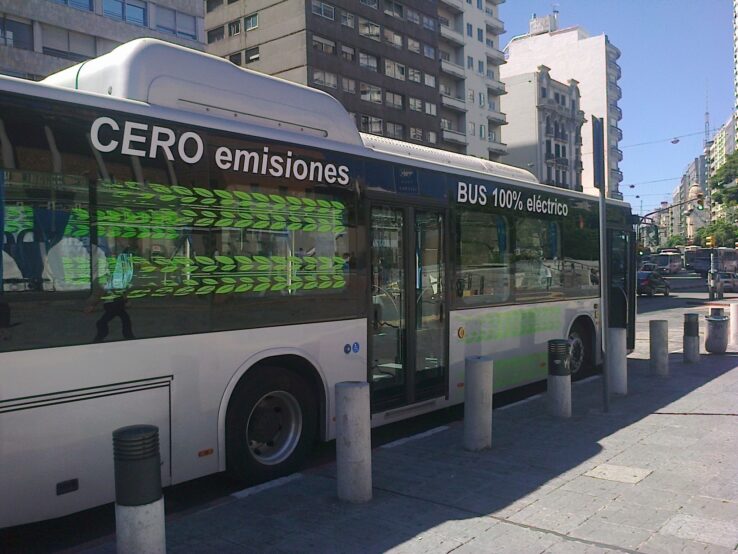 A zero-emission electric bus is parked on a downtown street in Montevideo. Public transport is beginning to electrify in Latin America's cities as a way to contain CO2 emissions, but plans have been delayed and cut back due to the covid pandemic. CREDIT: Inés Acosta/IPS