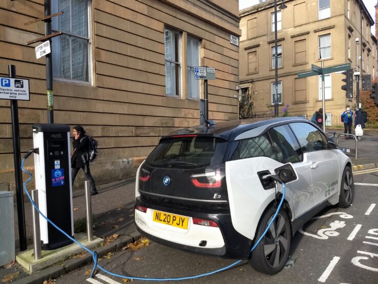 Electric vehicles are still a pipe dream in many indigenous communities, due to their price and the lack of charging infrastructure. In the picture, an electric car is charged at a station in downtown Glasgow, near COP26. CREDIT: Emilio Godoy/IPS