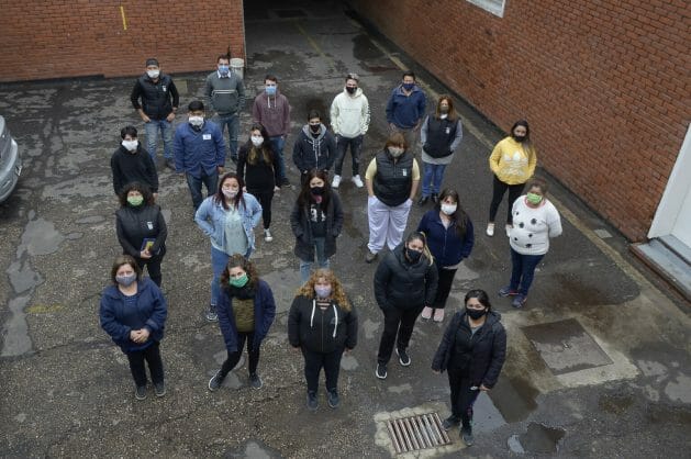 A group of Farmacoop workers stand in the courtyard of their plant in Buenos Aires. Members of the Argentine cooperative proudly say that theirs is the first laboratory in the world to be recovered by its workers. CREDIT: Courtesy of Pedro Pérez/Tiempo Argentino.