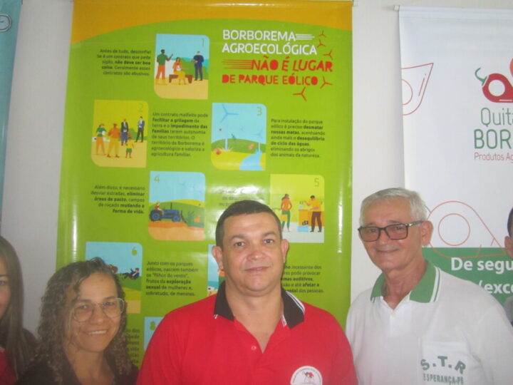 The president of the Union of Rural Workers of the municipality of Esperança, Alexandre Lira (C) and other leaders pose in front of a poster declaring the union's current goals: "Agroecological Borborema is no place for a wind farm," he says about this area in Brazil's semiarid Northeast region. CREDIT: Mario Osava / IPS