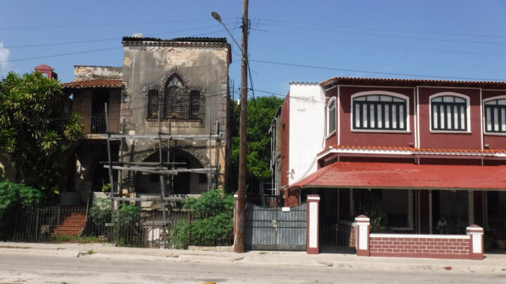 A rundown house stands next to a newly remodeled home on a street in the municipality of Playa, Havana. A third of Cuba's 3.9 million homes are considered to be in fair and poor condition. CREDIT: Jorge Luis Baños / IPS
