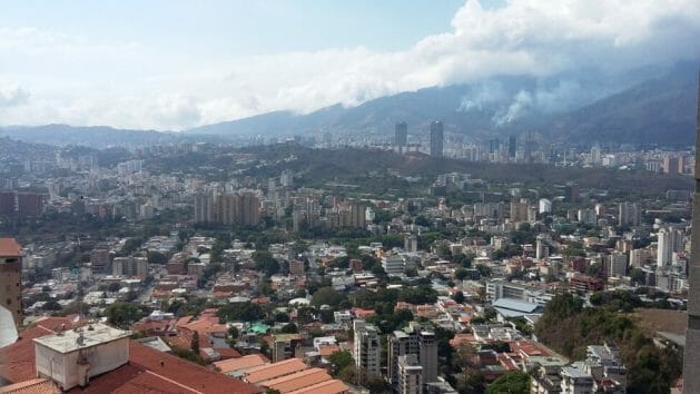 A view of Caracas from the south side of the narrow valley where it sits, dotted with houses and residential buildings where full occupancy was the norm until a few years ago. As a result of the massive migration of young people and adults, more and more homes are left unoccupied or inhabited only by the elderly and young children. CREDIT: Humberto Márquez / IPS