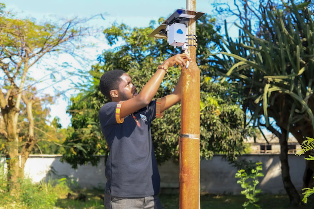 Air photo 1- A technician installs a low-cost air quality monitor sensor in Nairobi, Kenya. Air quality monitors are helping Nairobi collect data on air pollution. Credit: Jackson Okata/IPS
