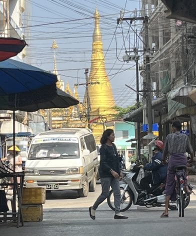 A Buddhist pagoda towers above a teeming thoroughfare in Mae Sot, a Thai town dense with tens of thousands of people fleeing conflict in nearby Myanmar. Credit: William Webb/IPS