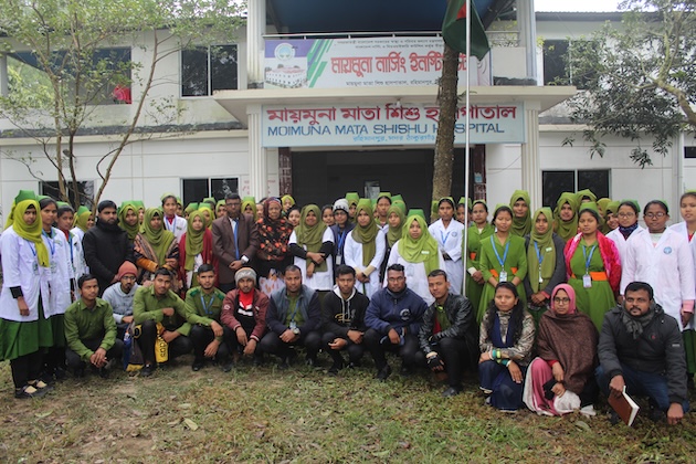 Teachers, students and staff of Moimuna Nursing Institute pose for a photo in front of its main building on the campus. Credit: Rafiqul Islam/IPS