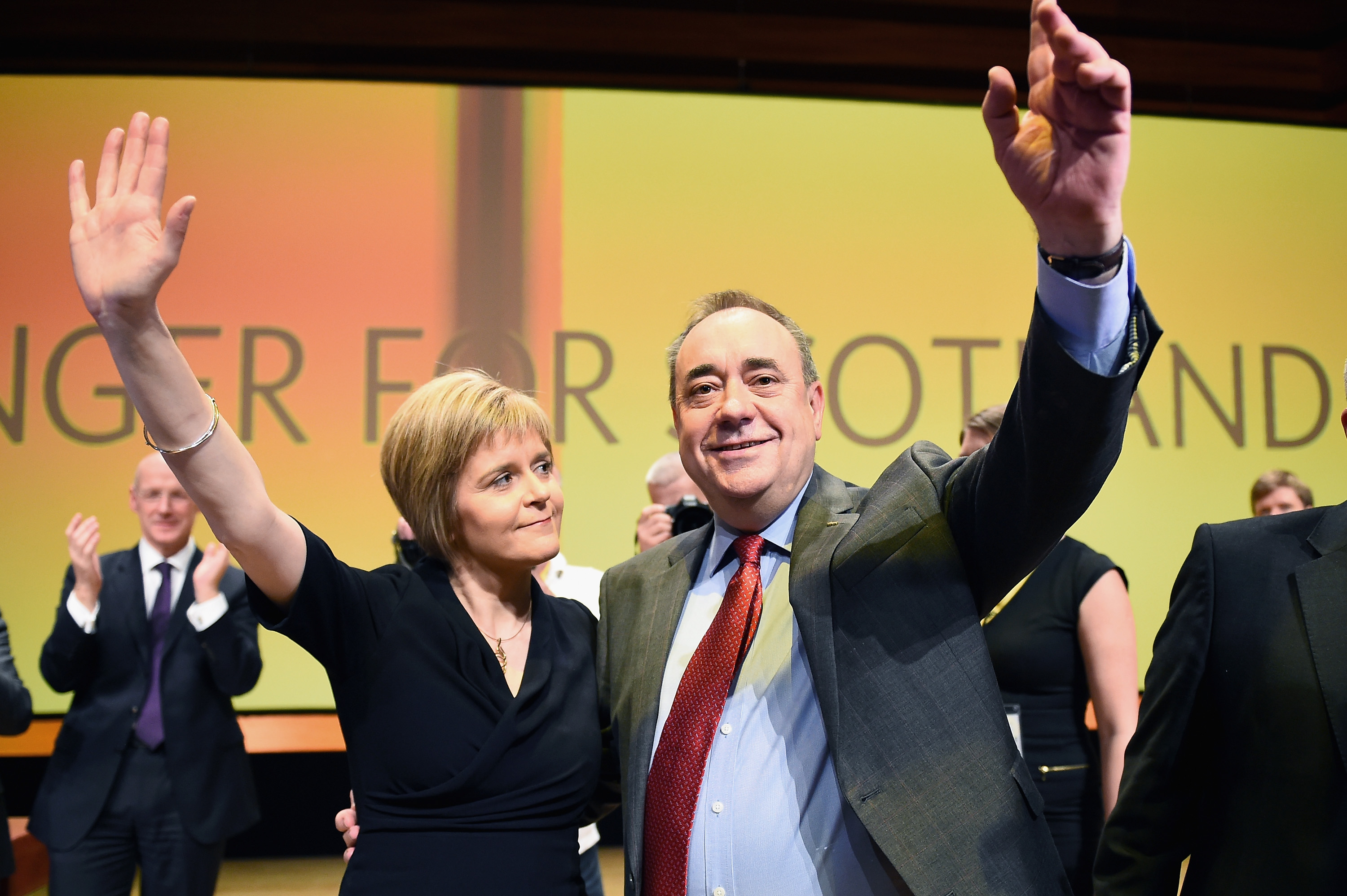 First Minister Alex Salmond and Nicola Sturgeon raise their hands in applause at the SNP annual conference.