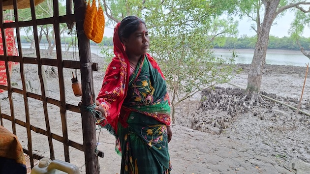 Geeta Rani Munda, 42, lives precariously in Datinakhali village, adjacent to the Sundarbans. She wants the Karam festival to return for her prosperity. Credit: Rafiqul Islam Montu/IPS